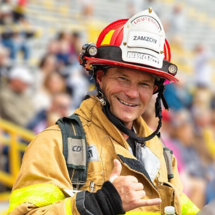 READYBAR advisor Aaron Zamzow smiling in firefighter gear.