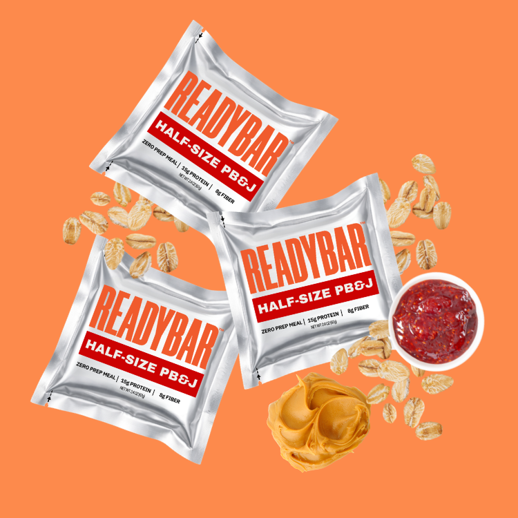 Three READYBAR Half-Size PB&J meal bars on an orange background with creamy peanut butter, oats, and strawberry jelly.