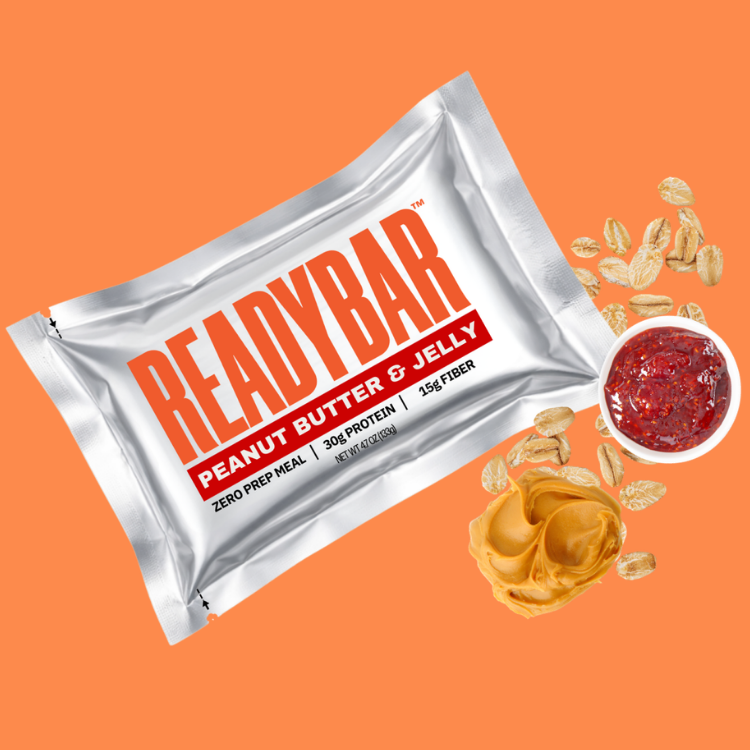 READYBAR Peanut Butter & Jelly mael bar on an orange background with peanut butter and jelly ingredients.